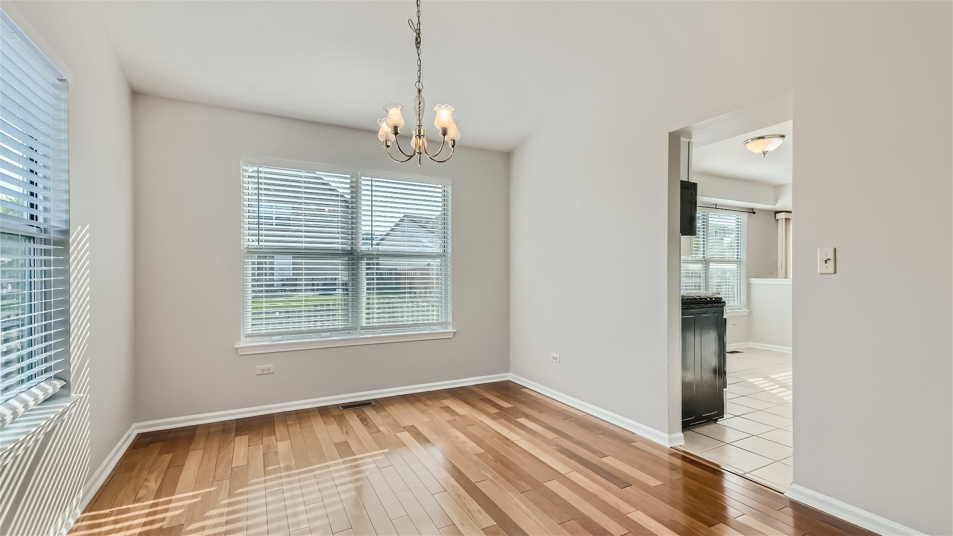 1223 Sumac Trail Hoffman Estates, IL 60192 - Photo 15 of 28 a view of empty room with wooden floor and fan