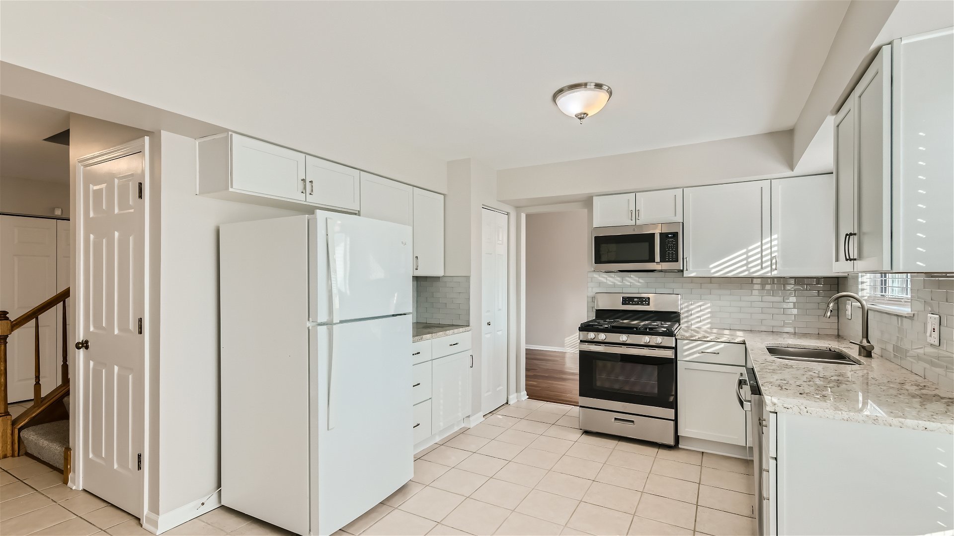 1223 Sumac Trail Hoffman Estates, IL 60192 - Photo 5 of 28 a kitchen with stainless steel appliances a refrigerator stove and white cabinets