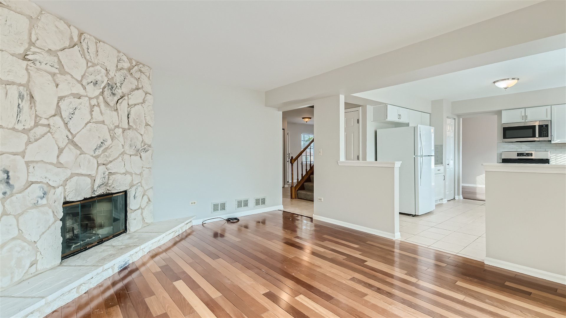 1223 Sumac Trail Hoffman Estates, IL 60192 - Photo 8 of 28 a view of empty room with a fireplace and wooden floor