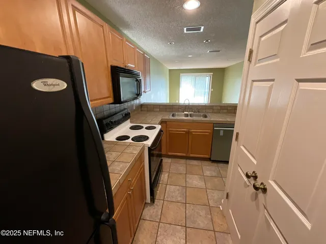 a kitchen with a stove and a microwave