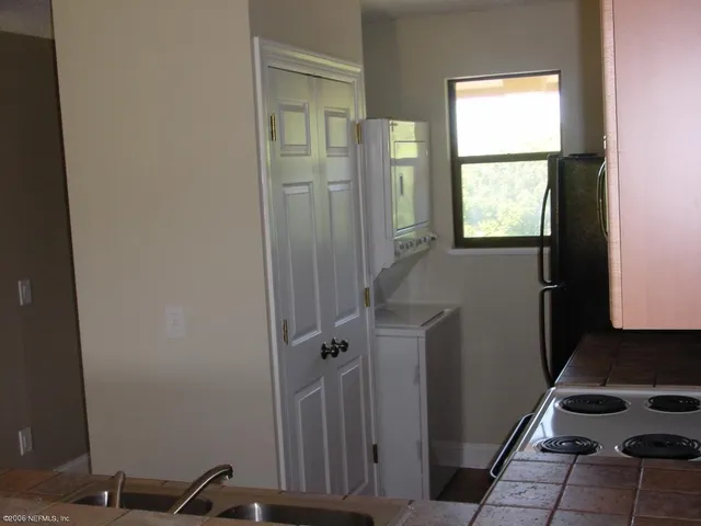 a kitchen with stainless steel appliances granite countertop a refrigerator a stove and a sink