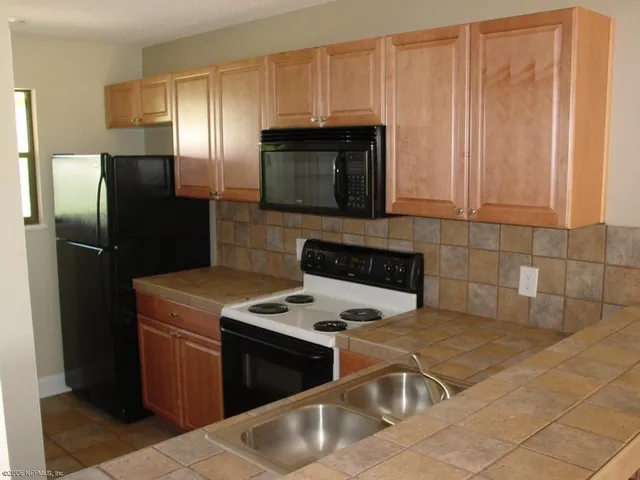 a bathroom with a sink a toilet and a shower