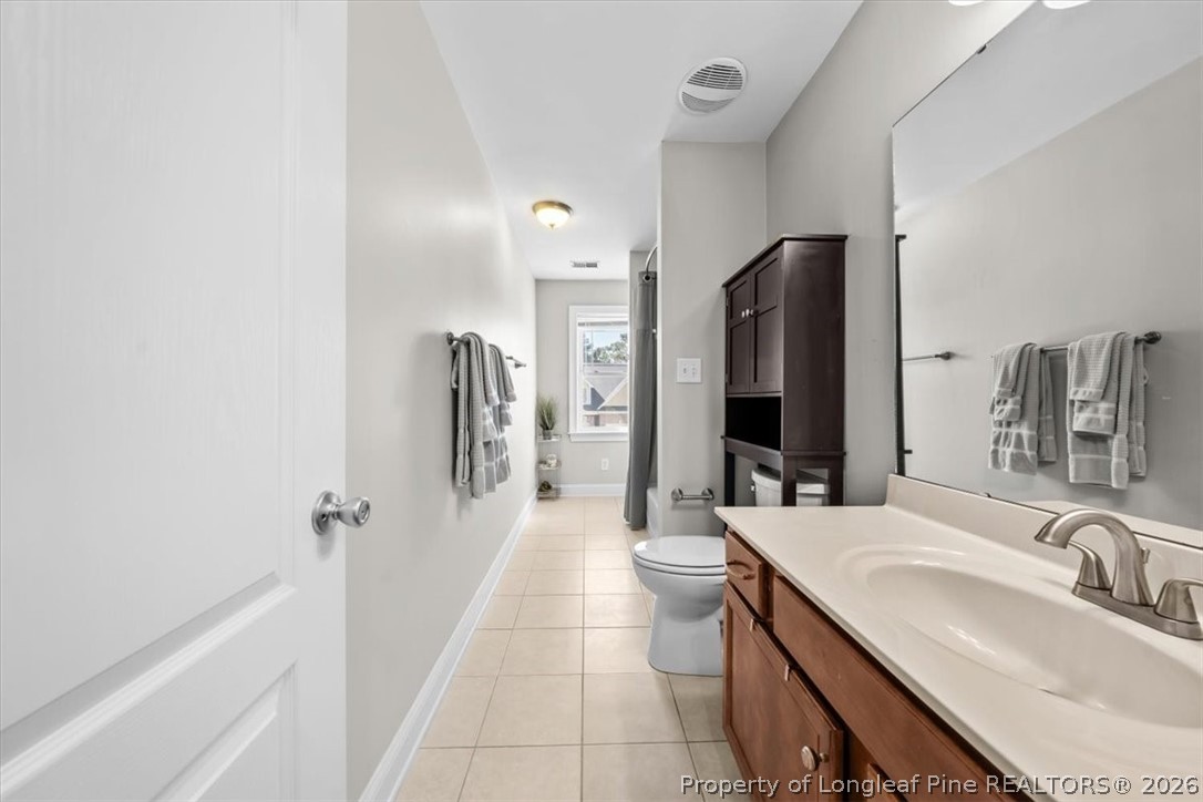 2708 Plum Ridge Road Fayetteville, NC 28306 - Photo 19 of 27 a bathroom with a sink a toilet and shower