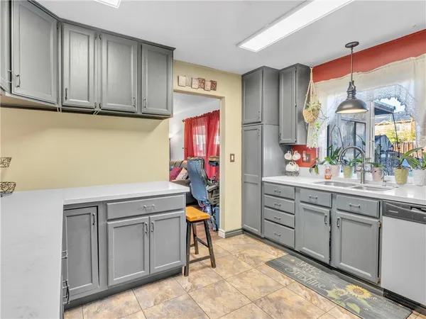 a kitchen with cabinets and window