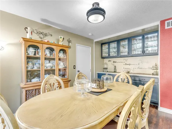 a view of a dining room with furniture and chandelier