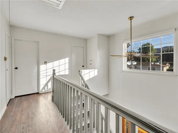 a view of entryway and hall with wooden floor