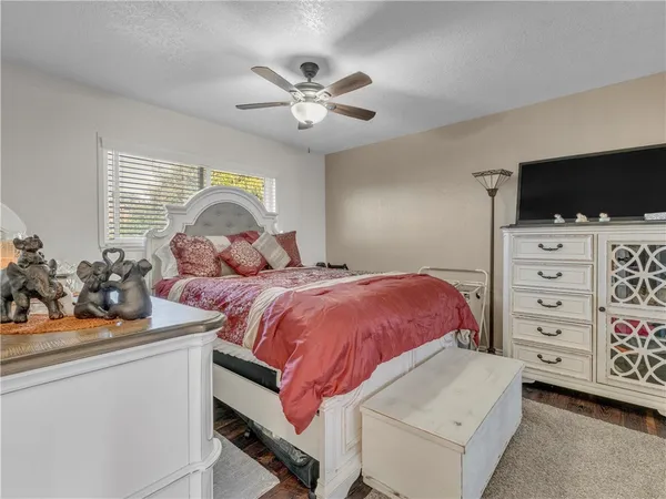 a bedroom with a bed and flat screen tv
