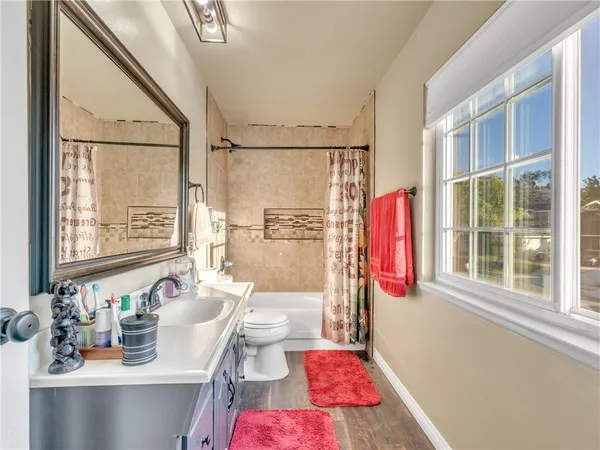 a bath room with a sink and a mirror