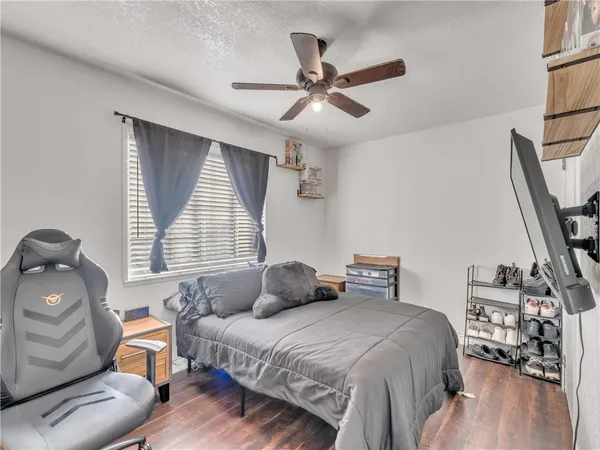 a bedroom with a bed and wooden floor