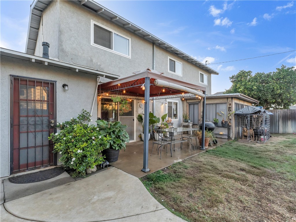 714 Appleton Road Simi Valley, CA 93065 - Photo 36 of 45 a patio with a table and chairs under an umbrella