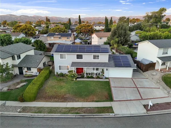 an aerial view of a house with a yard