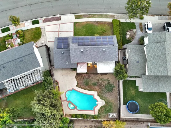 an aerial view of residential house with outdoor space and swimming pool