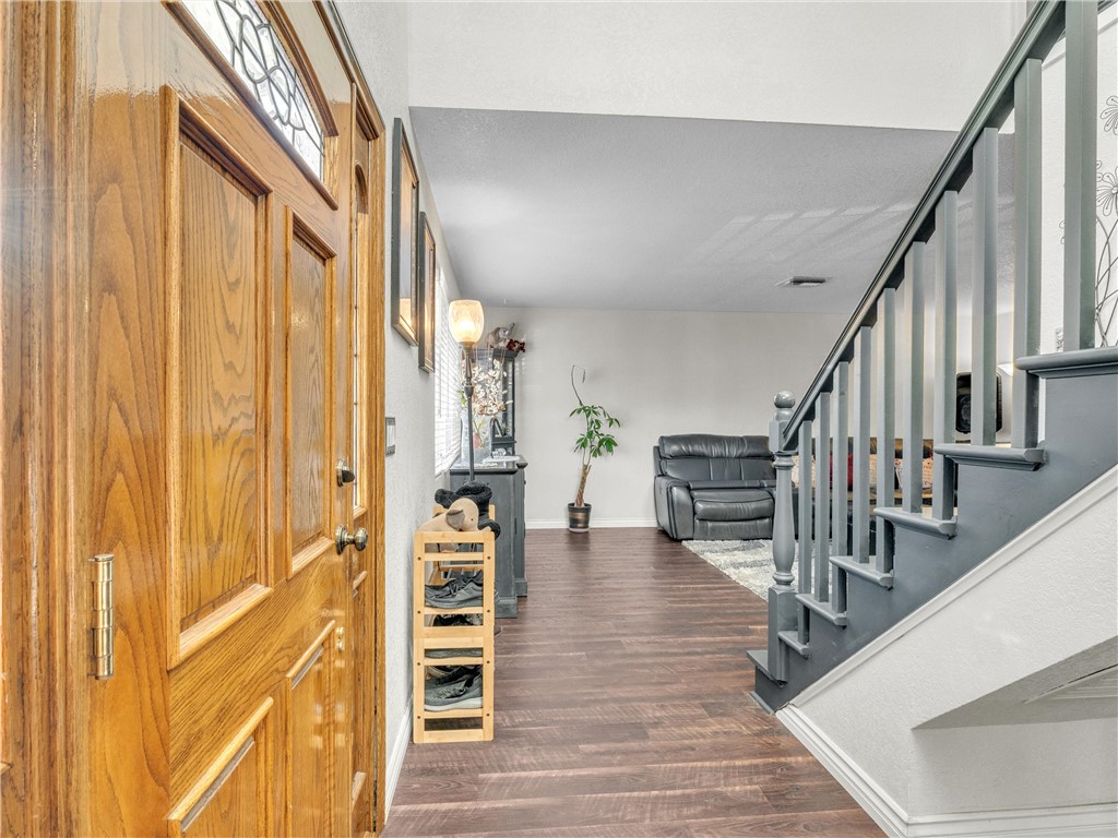714 Appleton Road Simi Valley, CA 93065 - Photo 5 of 45 a view of a hallway with wooden floor and staircase