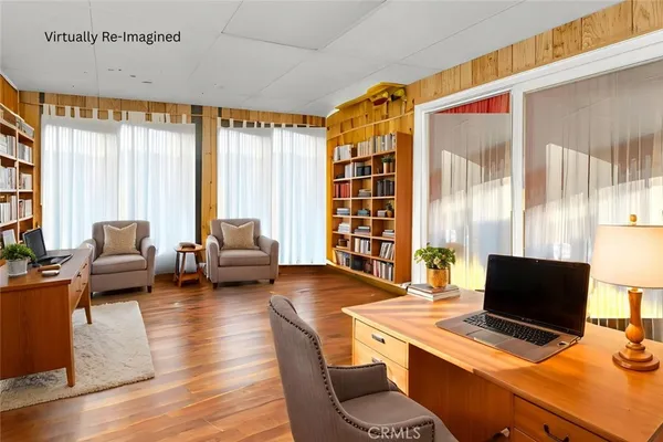 a view of a livingroom with workspace and a window