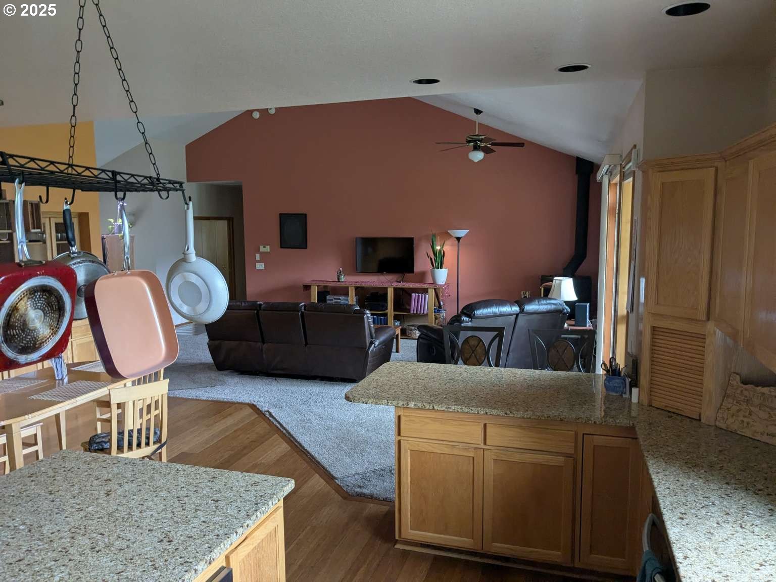4235 Jessen Drive Eugene, OR 97402 - Photo 31 of 31 a living room with furniture a flat screen tv and kitchen view