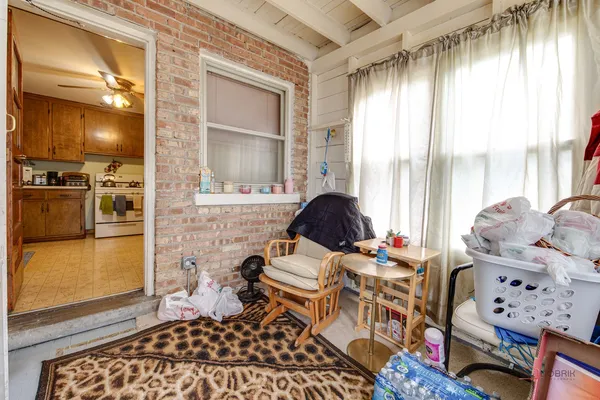 a bedroom with furniture and a large window