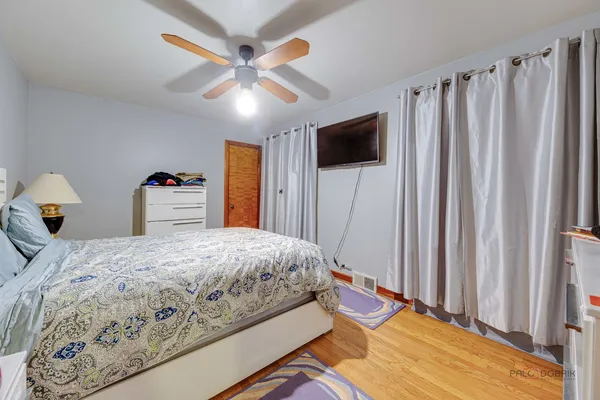 a bedroom with bed and a chandelier