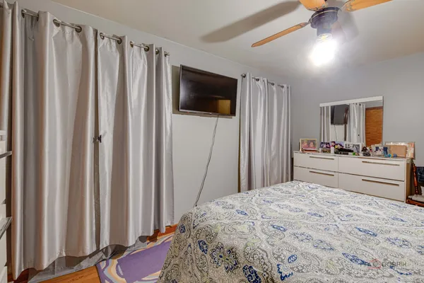 a bedroom with a bed and a television