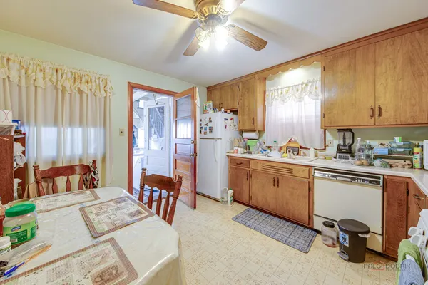 a open kitchen with stainless steel appliances granite countertop a stove a sink dishwasher and cabinets with wooden floor