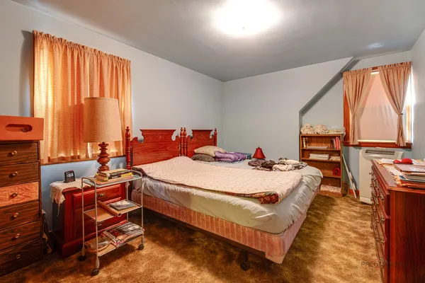 a bed sitting in a room next to a window