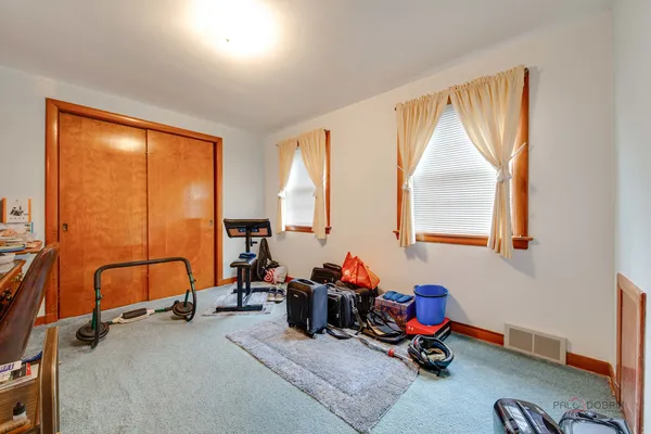 a room with gym equipment and a large window