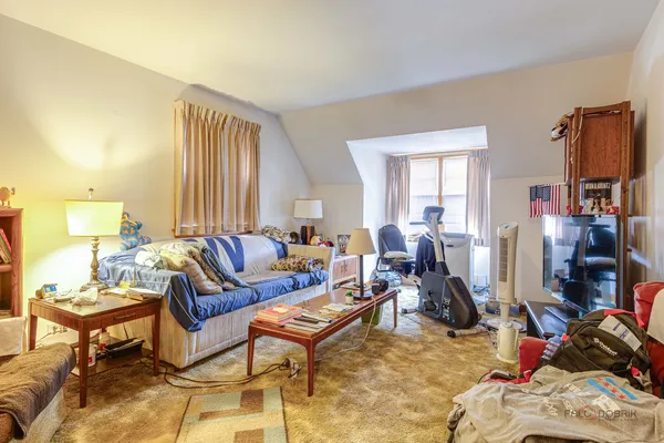 a living room with furniture a window and a flat screen tv