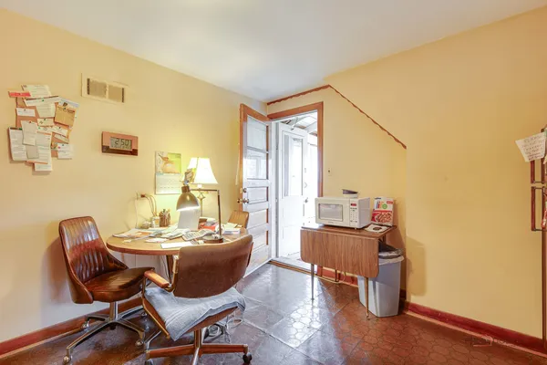a dining room with furniture and wooden floor