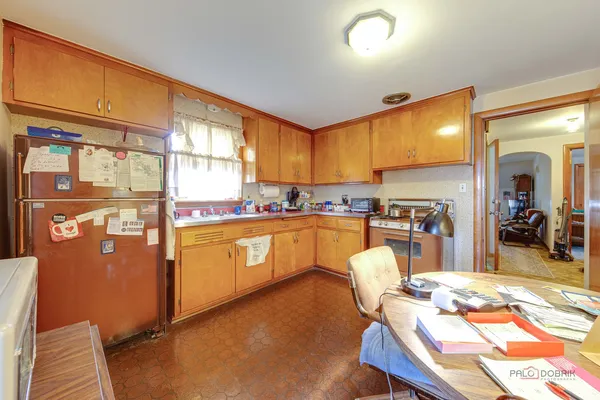 a kitchen with a sink cabinets and wooden floor