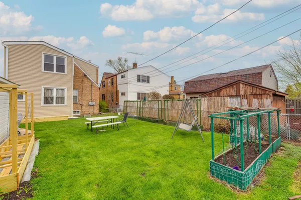 a view of a house with backyard and sitting area