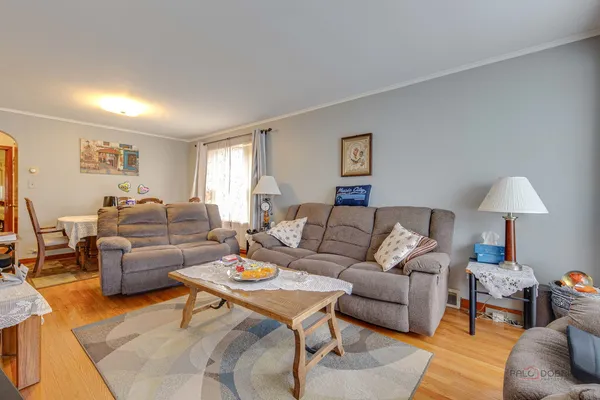 a living room with furniture and a lamp