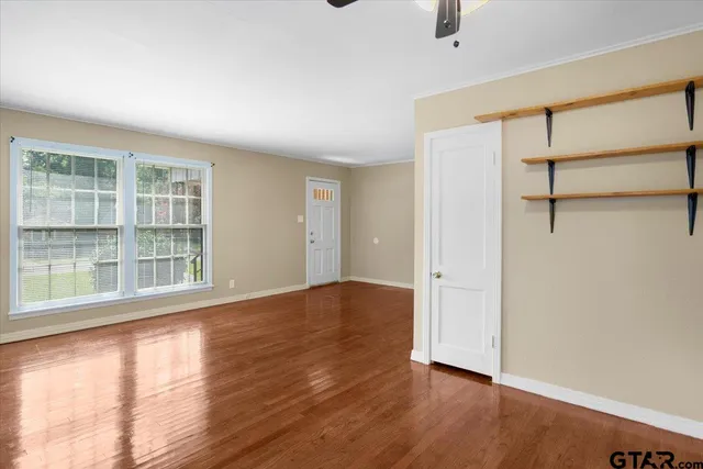 wooden floor in an empty room with a window