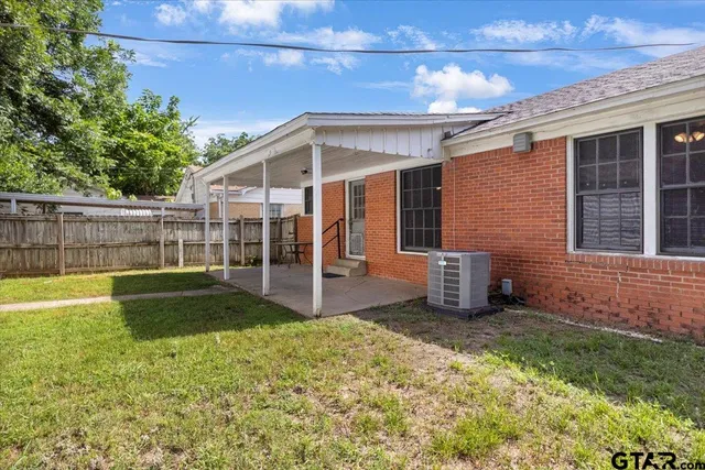 a view of a backyard with a garden and entertaining space