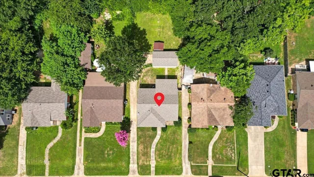 an aerial view of residential house with outdoor space and trees