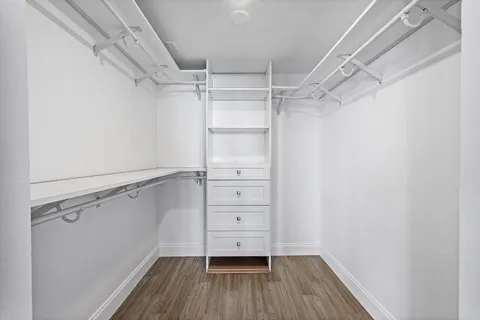 a view of walk in closet with empty racks