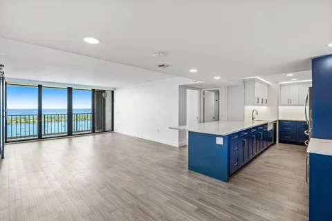 a large living room with wooden floors and a large window