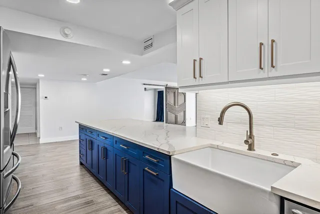 a kitchen with stainless steel appliances a sink and cabinets