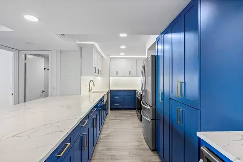 a kitchen with granite countertop cabinets and refrigerator