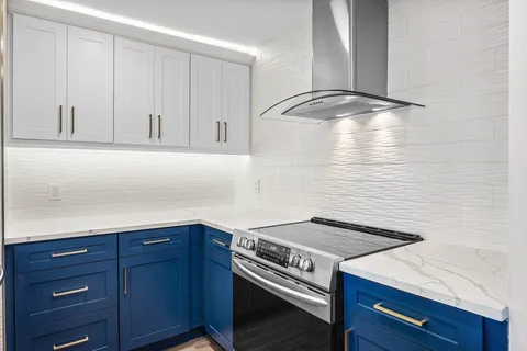 a kitchen with a cabinets and white stove