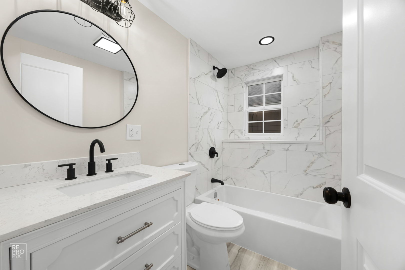 5147 Long Avenue Chicago, IL 60638 - Photo 9 of 17 a bathroom with a sink a toilet and a mirror