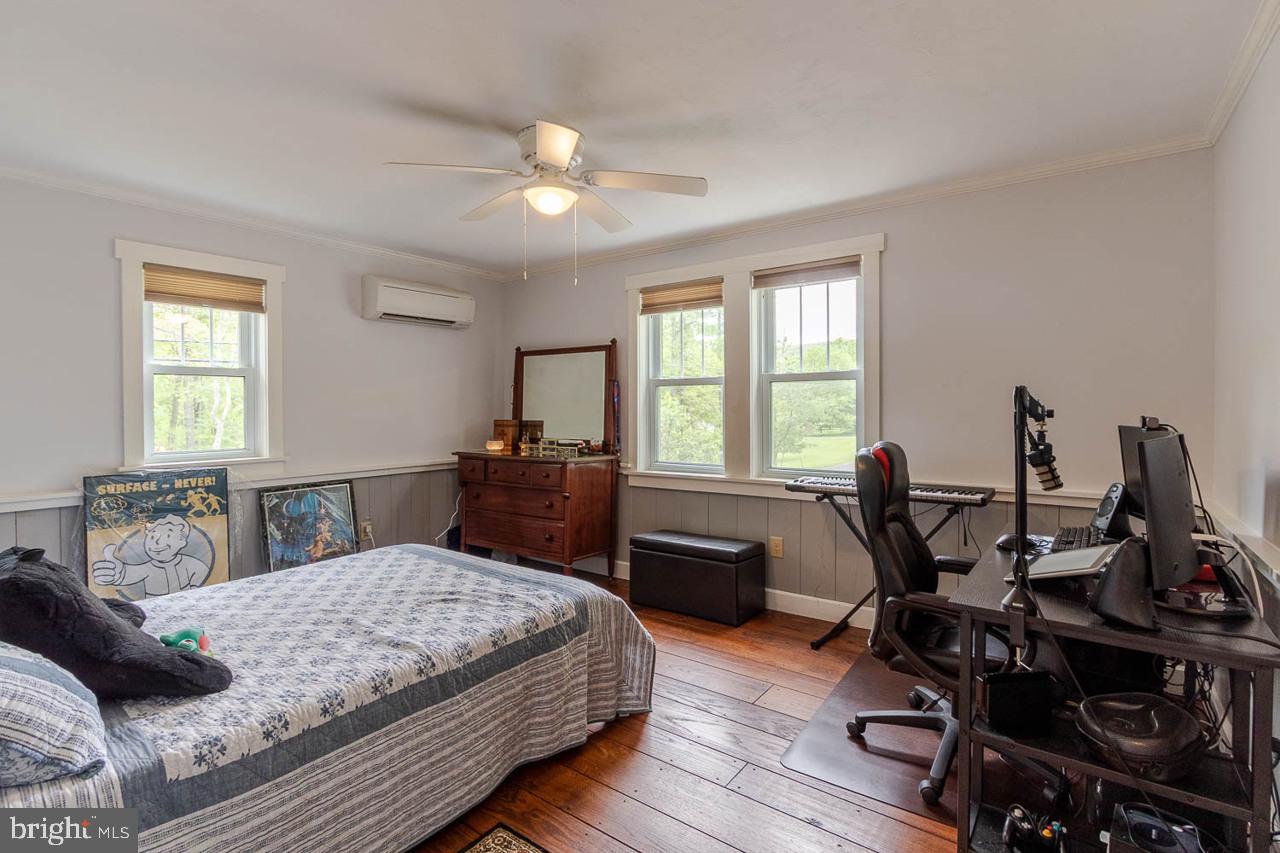 1834 Decker Hollow Road Tyrone, PA 16686 - Photo 24 of 40 a bedroom with a bed a large window and wooden floor