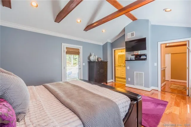 a bedroom with a bed dresser and a window