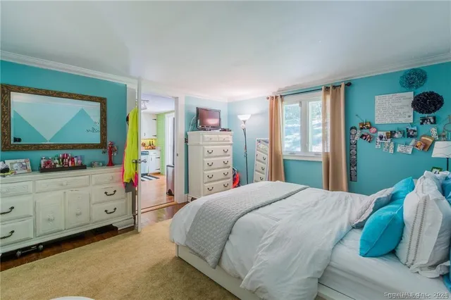 a bedroom with a bed and a dresser in it