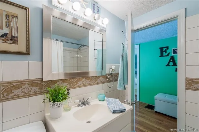 a bathroom with a sink mirror and a bathtub