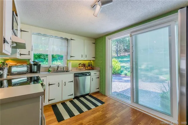 a kitchen with sink cabinets and outdoor view