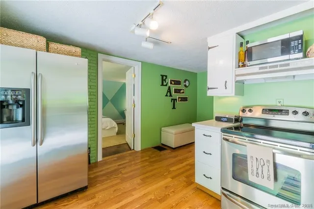 a kitchen with a stove and a refrigerator