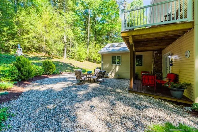 a view of a chairs and tables in the back yard of the house