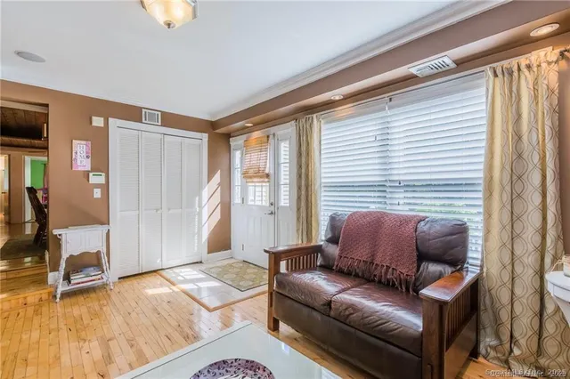 a living room with furniture and a wooden floor