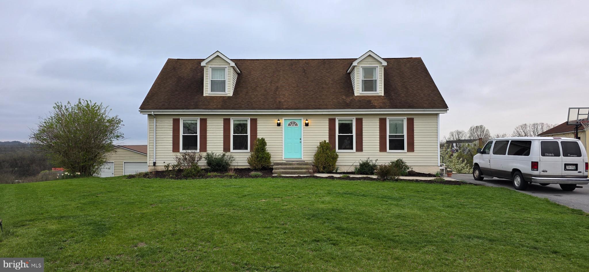a front view of a house with a garden