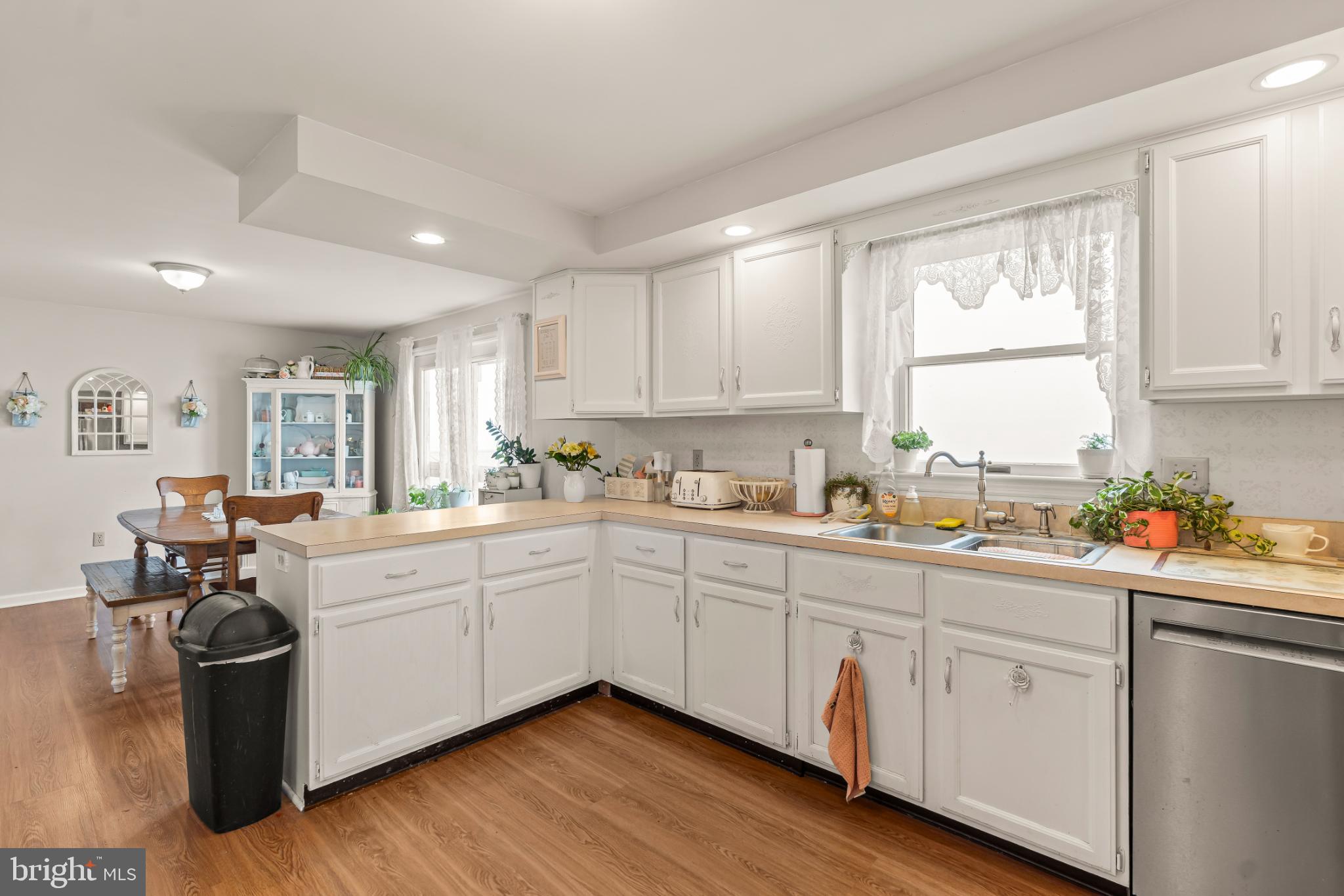 94 Tulip Court Falling Waters, WV 25419 - Photo 11 of 32 a kitchen with sink a window and chairs