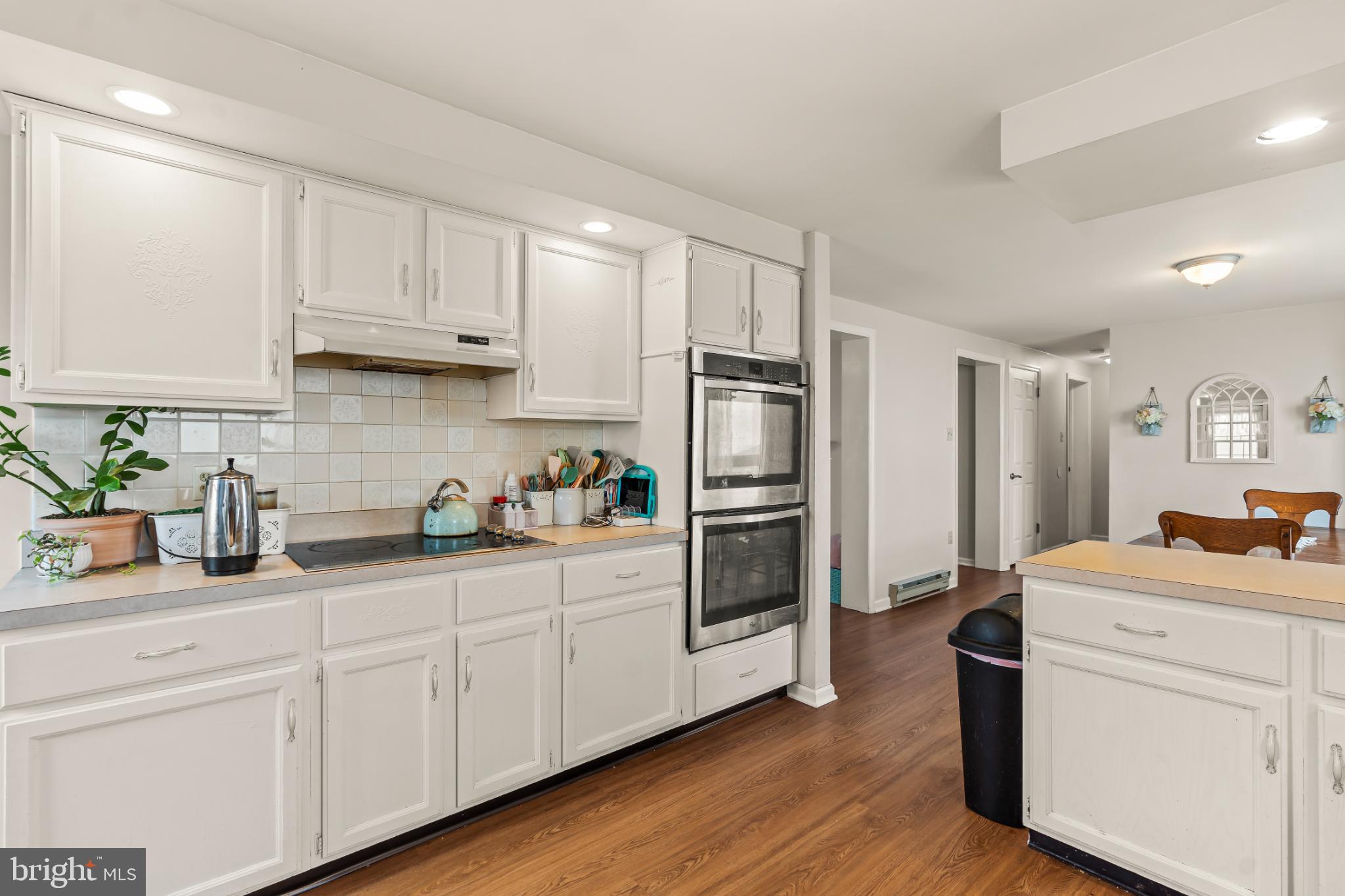 94 Tulip Court Falling Waters, WV 25419 - Photo 12 of 32 a kitchen with white cabinets and stainless steel appliances